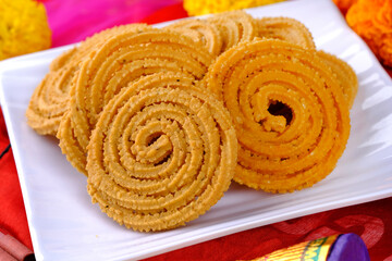 Indian Traditional Snack Chakli, a spiral shaped, Chakali or murukku Indian Traditional Tea Time Snack, Traditional Diwali festival snacks in India.
