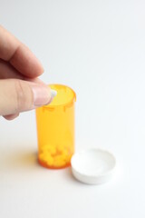 WASHINGTON - USA, October 28 2022 - Bottle of riteaid pills and pills placed on a man's hand and white background.