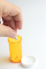 WASHINGTON - USA, October 28 2022 - Bottle of riteaid pills and pills placed on a man's hand and white background.