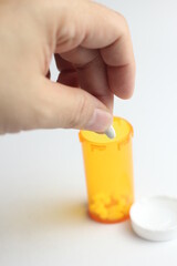 WASHINGTON - USA, October 28 2022 - Bottle of riteaid pills and pills placed on a man's hand and white background.