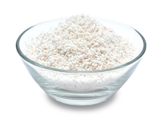 Perlite mineral composite fertilizer granules in glass bowl