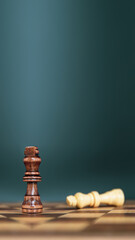 King chess pieces stand on falling chess in vertical concepts of leadership or wining to challenge...