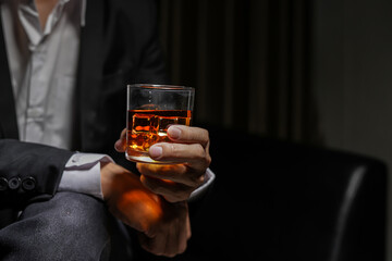 Closeup businessmen holding a glass of whiskey
