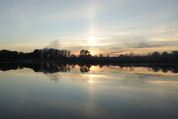 Beautiful sunset in clouds at the lake