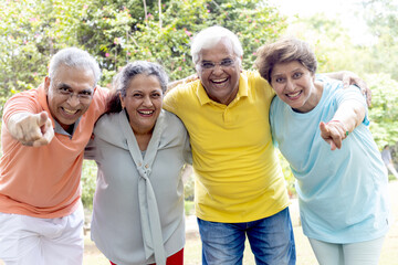 Group of happy senior couple in park