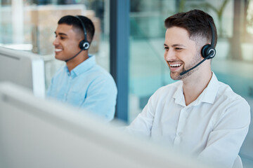 Happy call center, consultant man laugh on customer service phone call and happiness in office....
