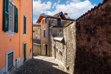 A curving hillside cobblestone road in the lakefront village of Varenna, Italy, on the shores of Lake Como.