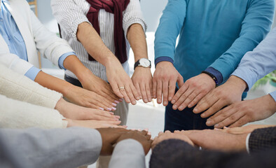 Group of business people put their hands together. Diverse team of men and women join hands. Cropped shot, closeup. Concept of teamwork, union, participation, support and collaboration