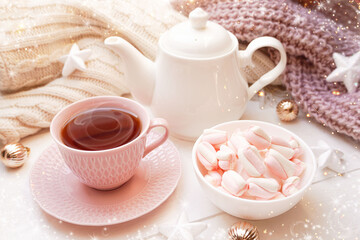  Winter, Christmas, New Year decorations composition, concept, background. White Mug, cup of tea, coffee, steam, meringue, knitted plaid. Christmas lights. Christmas mood morning. Christmas  card.