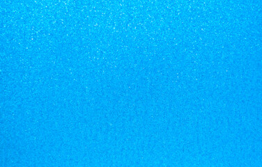 Fototapeta na wymiar Background with sequins. Shiny textured surface. Light blue texture with holographic gloss.
