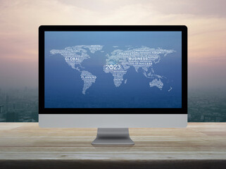 Start up business icon with global word world map on computer screen on table over city at sunset, vintage style, Happy new year 2023 business start up online, Elements of this image furnished by NASA