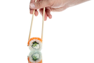 sushi with rice and salmon on a glass background with chopsticks. Japanese restaurant