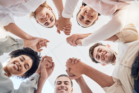 Teamwork, Support And Collaboration Of Happy Employees With Diversity, Synergy And Trust Holding Hands And Looking Down. Men And Women Team Building Circle For Mental Health Mission In Workplace