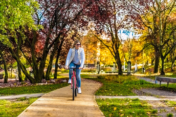 Woman riding bicycle in city park
