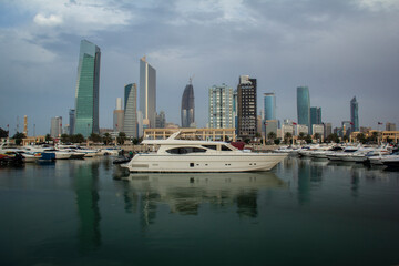 Fototapeta na wymiar Souk Sharq Kuwait City Building and Yacht with reflection 