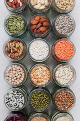 Vegan protein source. assortment of healthy vegetarian food. top view of seeds, nuts, peas, beans, spelt, oatmeal on white background