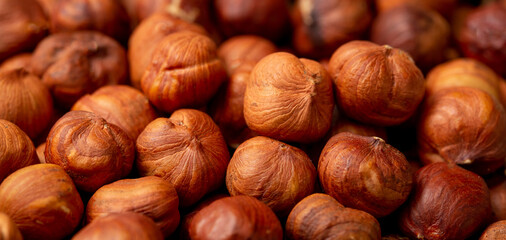 Heap of hazelnuts close-up. Peeled nuts. Hazelnut isolated on white background.
