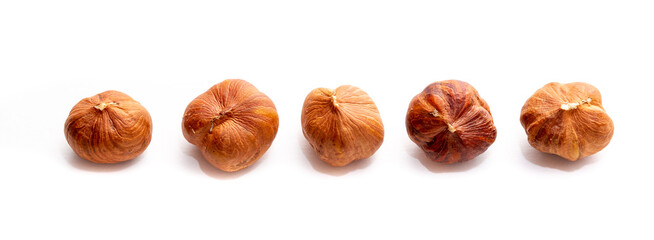 Heap of hazelnuts close-up. Peeled nuts. Hazelnut isolated on white background.