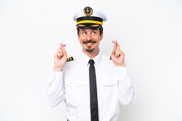 Airplane caucasian pilot isolated on white background with fingers crossing