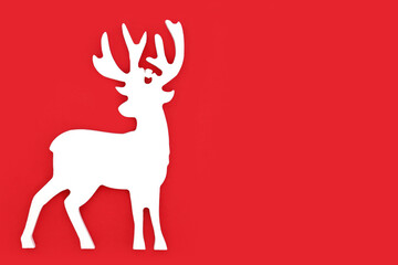 Christmas eve reindeer north pole festive minimal design on red background. Fun symbol for winter Xmas and New Year holiday season.