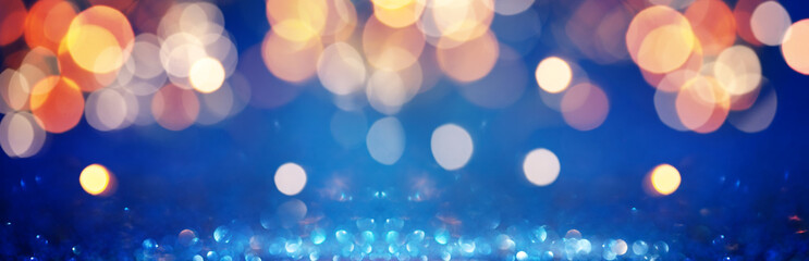 Abstract Festive Background with colorful glitter lights. Defocused backdrop and shine bokeh. Banner