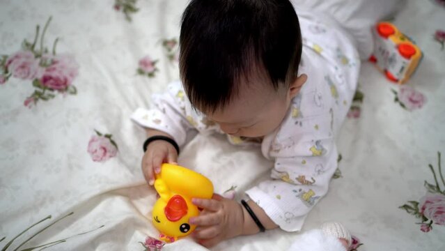 Chinese baby boy play rubber duck. Family, parenthood relationship concept