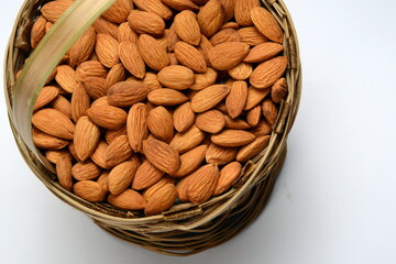 Fresh almonds in the wooden bowl, Organic almonds, almonds border white background, Almond nuts on a dark wooden background. Healthy snacks. Top view. Free space for text.