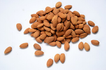 Fresh almonds in the wooden bowl, Organic almonds, almonds border white background, Almond nuts on a dark wooden background. Healthy snacks. Top view. Free space for text.