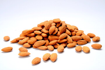 Fresh almonds in the wooden bowl, Organic almonds, almonds border white background, Almond nuts on a dark wooden background. Healthy snacks. Top view. Free space for text.