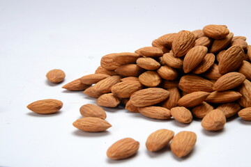 Fresh almonds in the wooden bowl, Organic almonds, almonds border white background, Almond nuts on a dark wooden background. Healthy snacks. Top view. Free space for text.