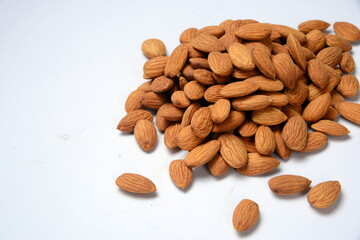 Fresh almonds in the wooden bowl, Organic almonds, almonds border white background, Almond nuts on a dark wooden background. Healthy snacks. Top view. Free space for text.