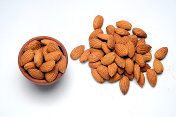 Fresh almonds in the wooden bowl, Organic almonds, almonds border white background, Almond nuts on a dark wooden background. Healthy snacks. Top view. Free space for text.