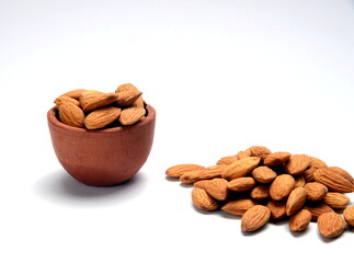 Fresh almonds in the wooden bowl, Organic almonds, almonds border white background, Almond nuts on a dark wooden background. Healthy snacks. Top view. Free space for text.