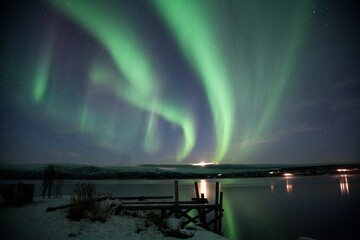 Scenery of the Northern lights (Aurora Borealis) in Iceland with mirroring on the lake at night
