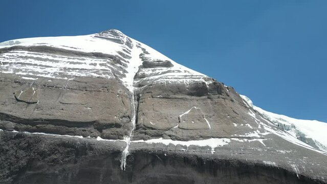 Aerial footage of a black snowy rock in the area of the sacred Mount Kailash, Tibet