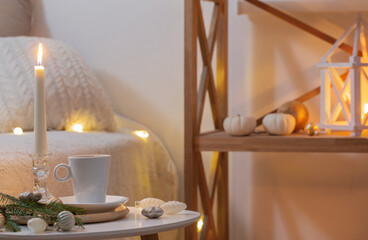 cup of tea on table with white decorations in white interior