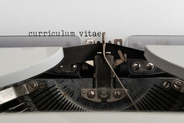 close-up of words CURRICULUM VITAE written on old mechanical typewriter