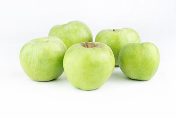 On a white background, green apples of the Semerenko variety.
