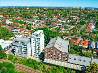Fototapeta premium Panoramic Aerial Drone view of Suburban Sydney housing, roof tops, the streets and the parks
