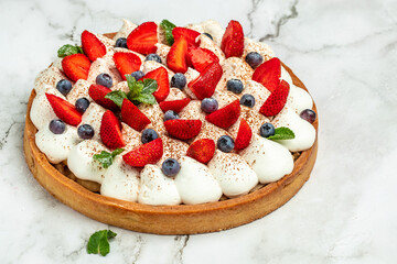 Sweet Cheese cakes tart pie with fresh berries on a light background. Top view