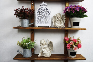 white lantern with ceramic dolls and artificial plant Interior home decoration on wooden shelf