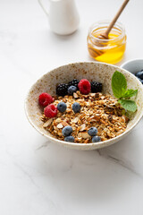 grains granola with fresh berries in white bowl breakfast food concept blueberry vegan milk