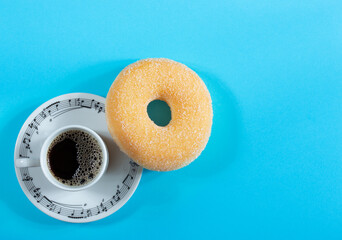 Coffee cup with donut on blue