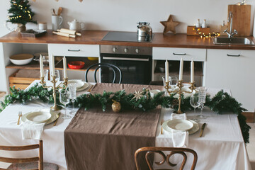 New Year's table setting. Waiting for Christmas. Kitchen interior with decoration. 