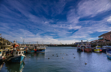 Fototapeta na wymiar Boats moored in Scarborough Harbour on a sunny autumn day.