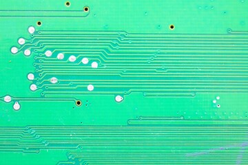 Green PCB board with stripes and lead welding points.