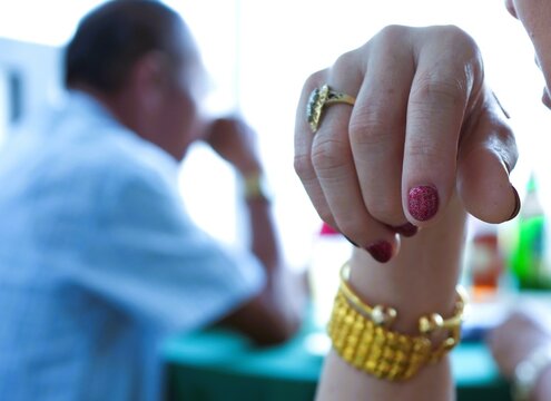 female finger red nail polish