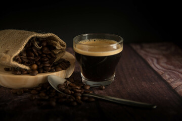 Coffee cup with coffee beans on dark background. Copy Space.