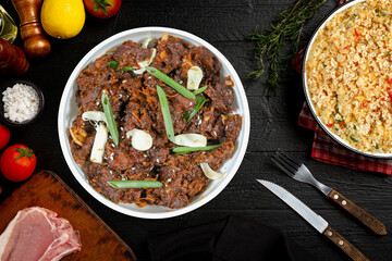 Mongolian beef with fried rice dark wooden surface