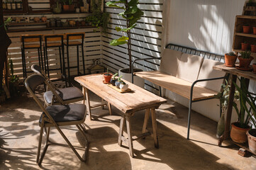 Retro cafe design with wooden table, chair and cactus vase decorate on yard